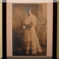 A05. Large antique photographic print of a woman in a white dress. 